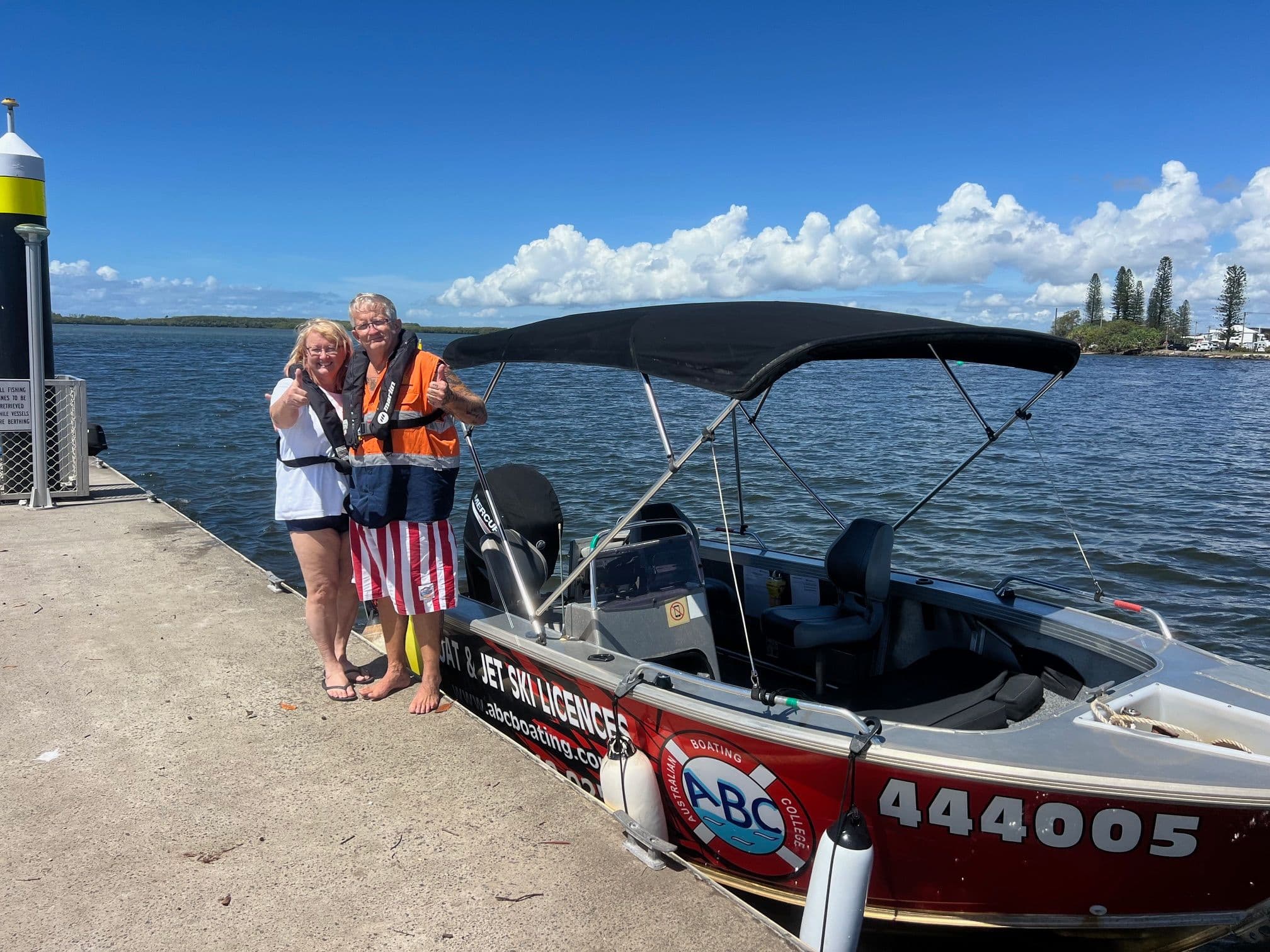 Students with the ABC Boating training boat after their Queensland boat licence course